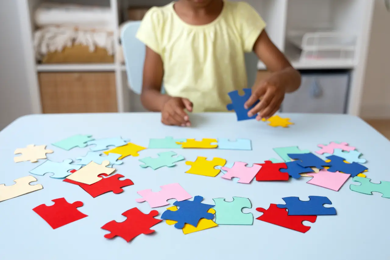 girl-making-puzzle-table-front-view
